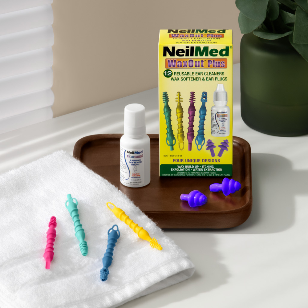 NeilMed WaxOut Plus ear cleaning product set on a tray with a plant in the background