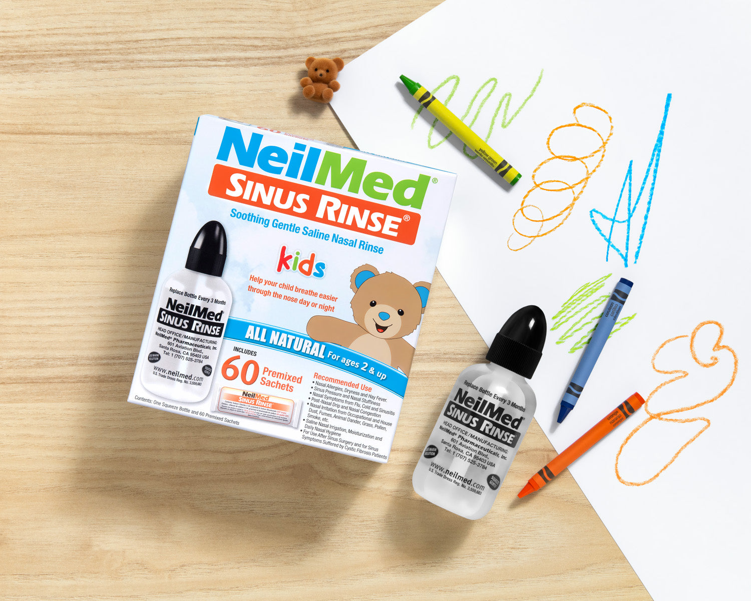NeilMed Sinus Rinse product packaging and bottle on a wooden surface with coloring book and crayons.
